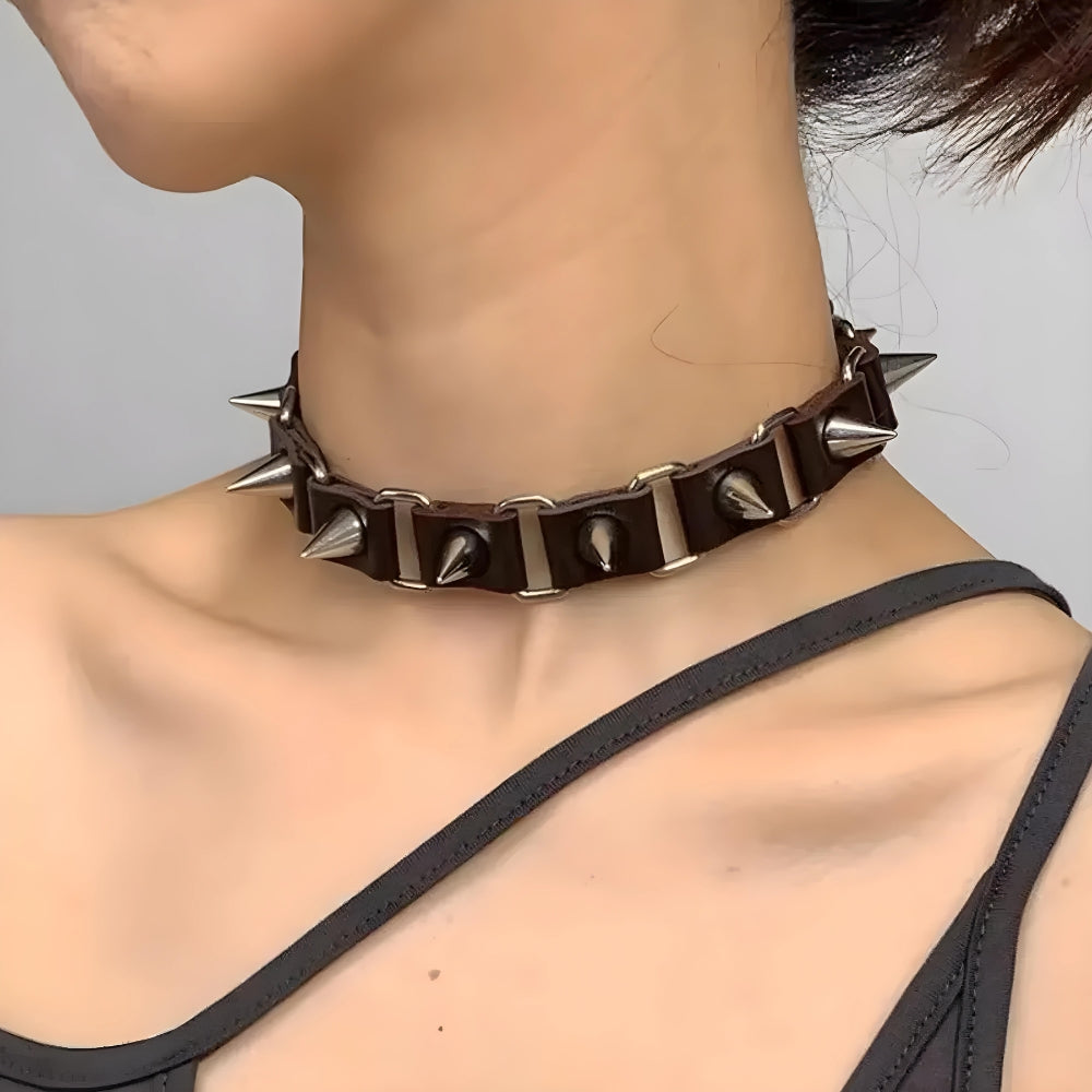 a girl is wearing a vampire punk goth barbed choker necklace in black and silver details